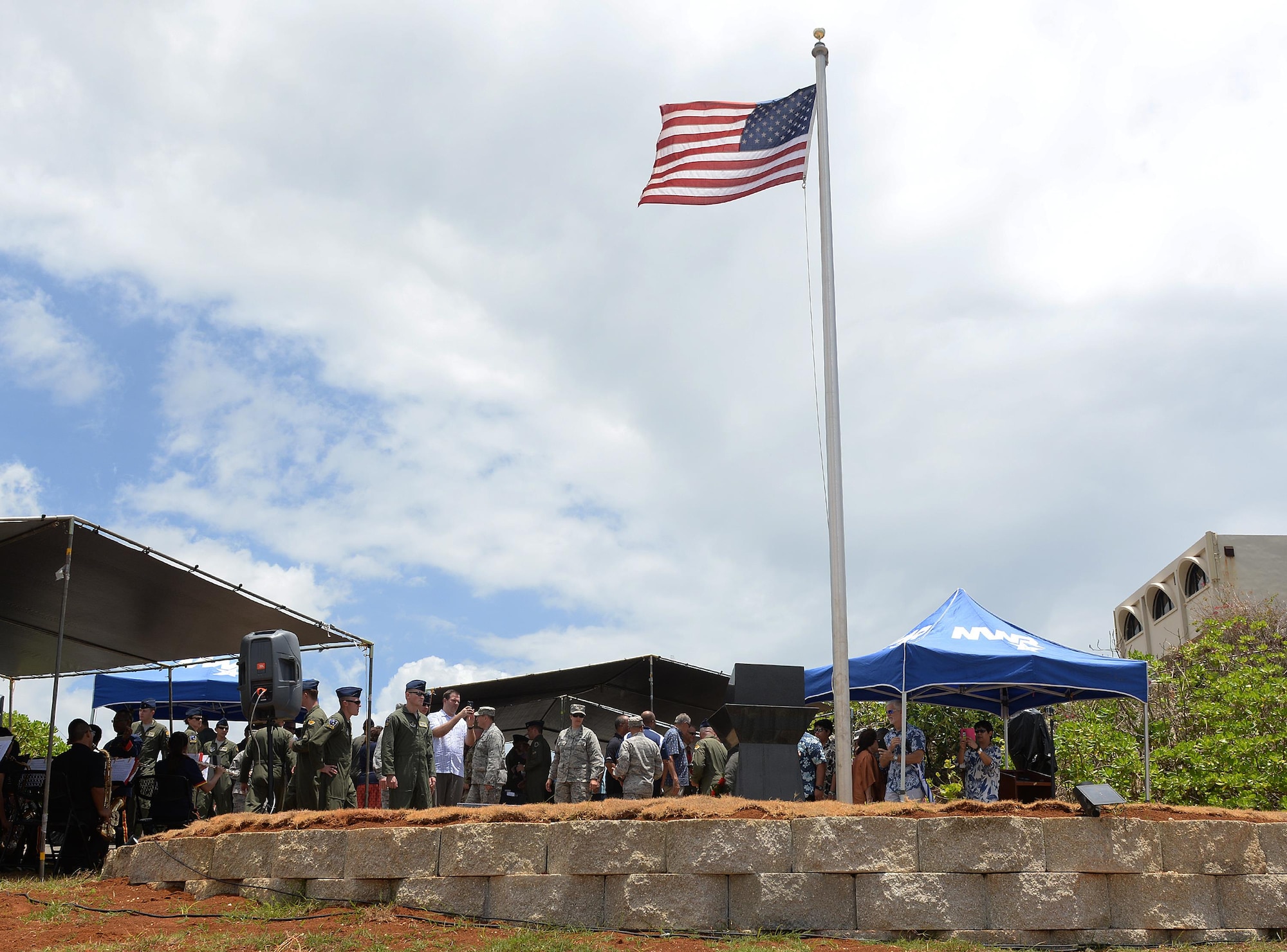 Attendees of the RAIDR 21 Re-dedication ceremony gather around the RAIDR 21 monument May 28, 2016, in Adelup, Guam. The monument was beautified by Alex Wood, a boy scout, who constructed a retaining wall, painted the surrounding area and cleaned the monument. The monument honors six B-52 Stratofortress crew members who lost their lives during a training mission July 21, 2008. The six aviators, from the 20th Expeditionary Bomb Squadron, were slated to participate in a flyover for Guam's Liberation Day Parade. (U.S. Air Force photo by Staff Sgt. Benjamin Gonsier)