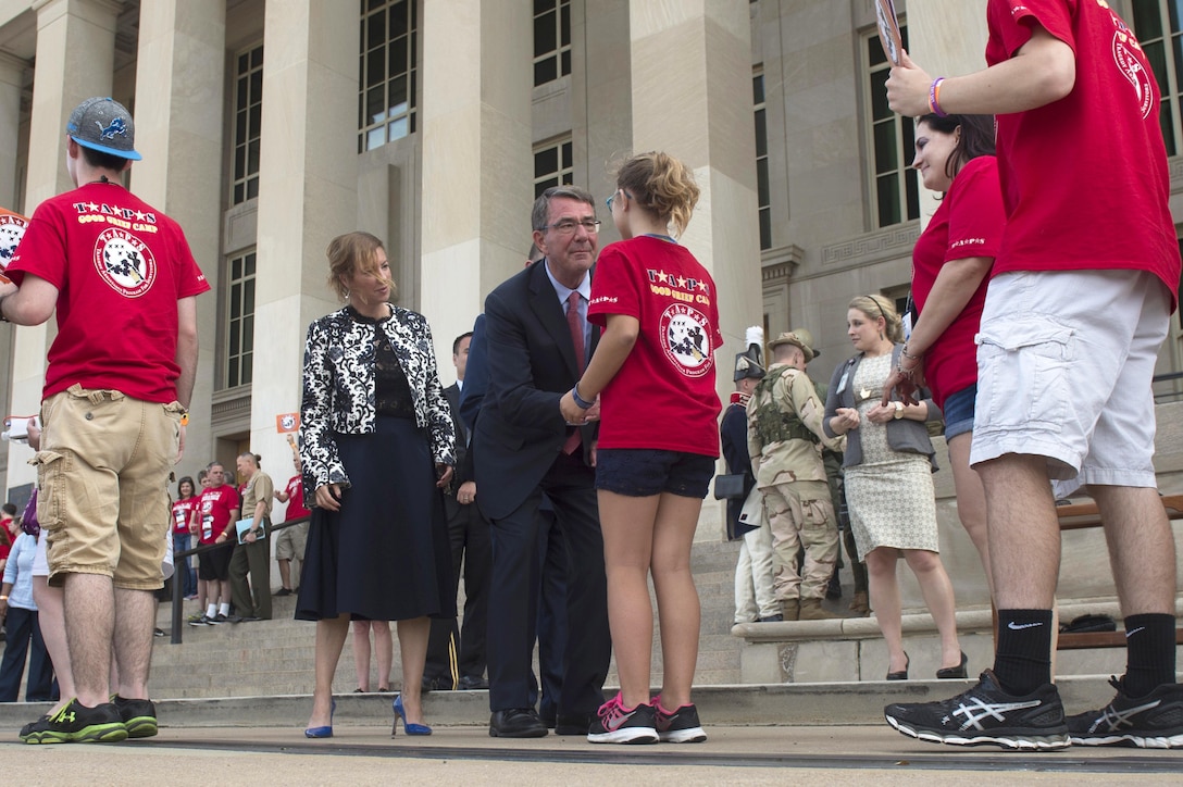 Defense Secretary Ash Carter greets a young guest as he and his wife, Stephanie, welcome members of the Tragedy Assistance Program for Survivors, or TAPS, to the Pentagon, May 27, 2016, for a night of fun and remembrance to coincide with Memorial Day weekend. DoD photo by Air Force Senior Master Sgt. Adrian Cadiz