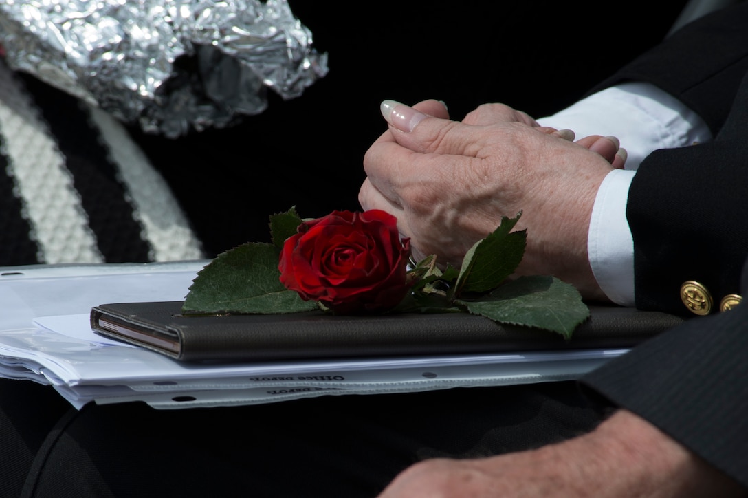 A rose is displayed on a folder belonging to Marilynn Rustand Lieurance, daughter of U.S. Army Air Corps 1st Lt. Hanford "Rusty" J. Rustand, a B-17 bomber pilot killed in World War II, during a Memorial Day ceremony at the Luxembourg American Cemetery and Memorial in Luxembourg, May 28, 2016. Rustand died when his B-17 came under enemy fire during a mission near Merseburg, Germany, and crashed on Nov. 2, 1944, nearly half a year before Lieurance was born. (U.S. Air Force photo by Staff Sgt. Joe W. McFadden/Released)