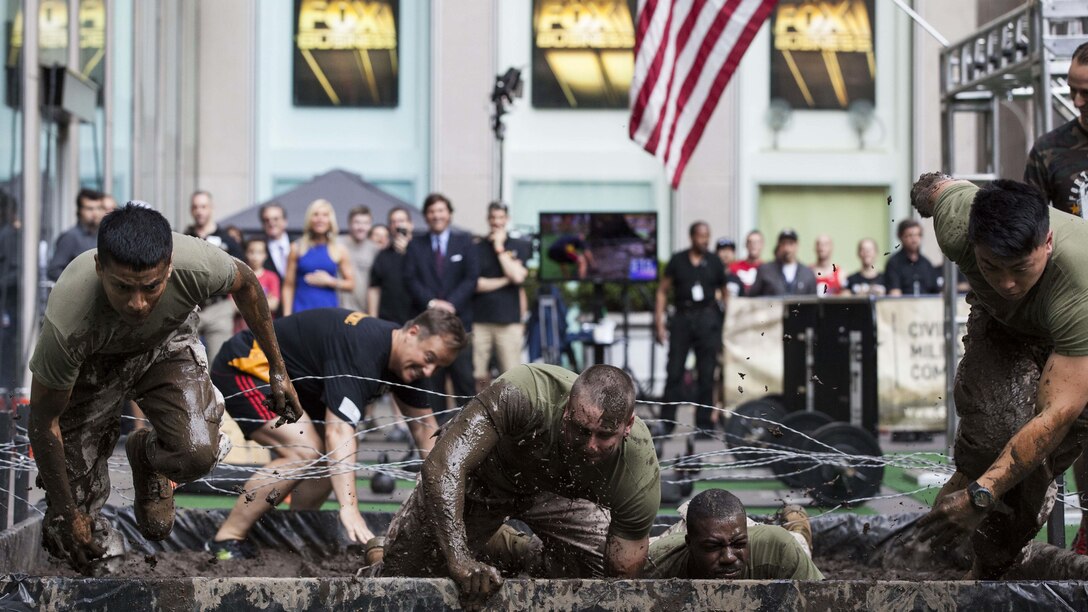 Marines with the 24th Marine Expeditionary Unit compete in an obstacle course during the Fox and Friends Weekend news program, May 28, 2016. U.S. Marines and sailors are in New York for Fleet Week to interact with the public, demonstrate capabilities and teach the people of New York about America's sea services. U.S. Marines and sailors are in New York to interact with the public, demonstrate capabilities and teach the people of New York about America's sea services. 