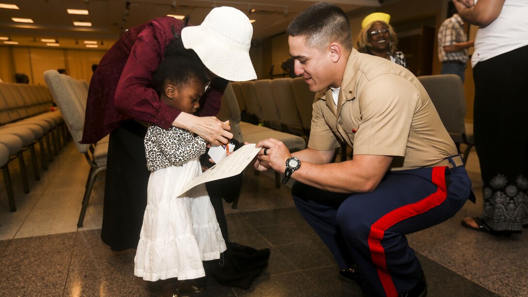 2nd Lt. Marc Martinez, a platoon commander with 3rd Battalion, 6th Marine Regiment, helps a girl complete an ice breaking exercise during an effort to bring aid and support to children in need at Times Square Church in New York, May 28, 2016. Fleet Week New York is an opportunity for the public to interact with service members from America’s sea services, spreading awareness of the Navy and Marine Corps’ missions at home and abroad.