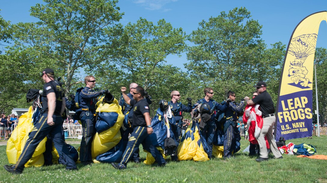 Members of the U.S. Navy Parachute Team, or the Leap Frogs, congratulate one another after an aerial parachute demonstration during Military Day as part of Fleet Week at Eisenhower Park in East Meadow, New York, May 28, 2016. The Marines and sailors are visiting to interact with the public, demonstrate capabilities and teach the people of New York about America’s sea services.