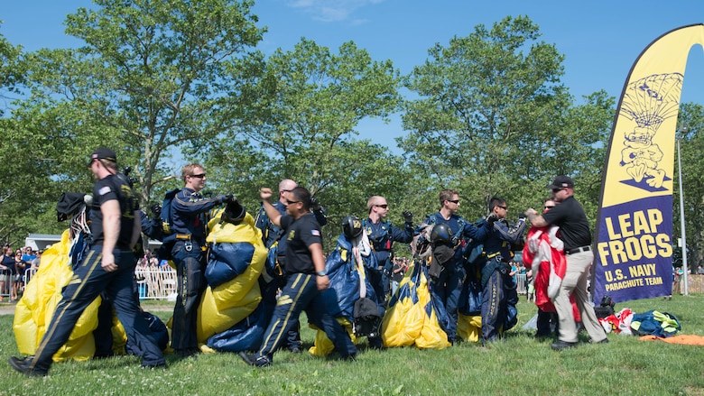 Members of the U.S. Navy Parachute Team, or the Leap Frogs, congratulate one another after an aerial parachute demonstration during Military Day as part of Fleet Week at Eisenhower Park in East Meadow, New York, May 28, 2016. The Marines and sailors are visiting to interact with the public, demonstrate capabilities and teach the people of New York about America’s sea services.