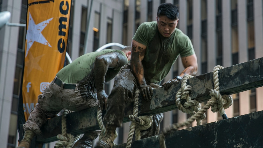 Marines with the 24th Marine Expeditionary Unit climb a rope wall obstacle course during the Fox and Friends Weekend news program, May 28, 2016. U.S. Marines and sailors are in New York for Fleet Week to interact with the public, demonstrate capabilities and teach the people of New York about America's sea services.
