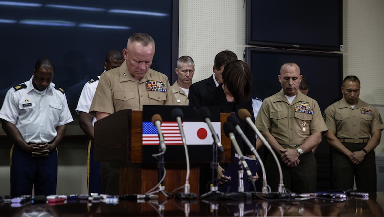 Lt. Gen. Lawrence D. Nicholson holds a moment of silence as he announces a 30-day period of unity and mourning for all U.S. military and Status of Forces Agreement personnel on Okinawa, at a press conference on Camp Foster, Okinawa, Japan, May 28, 2016. Out of respect for the people of Okinawa, Nicholson chose to demonstrate the solidarity of the U.S. service members here and the people of Okinawa by honoring the recent loss of an Okinawan female. The period of unity and mourning was directed to all U.S. military, and Nicholson also highly encouraged all SOFA-status members to partake, as this period will serve as a time to reflect on personal conduct, to consider their roles as ambassadors to Japan, and demonstrate the deepest sympathies for the victim and her family. Nicholson, from Toronto, Canada, is the Okinawa Area Coordinator and commanding general for III Marine Expeditionary Force. (U.S. Marine Corps photo by Lance Cpl. Jessica N. Etheridge/Released)