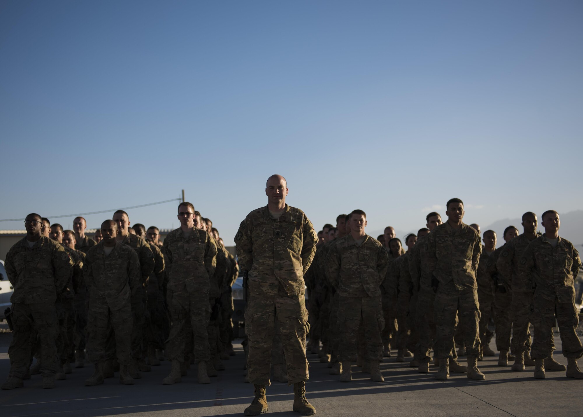 Airmen from the 455th Expeditionary Civil Engineer Squadron stand in formation before the commencement of a flag retirement ceremony at Bagram Airfield, Afghanistan, May 28, 2016. The ceremony is held to pay respect to and properly retire a flag that is no longer serviceable. (U.S. Air Force photo by Senior Airman Justyn M. Freeman)