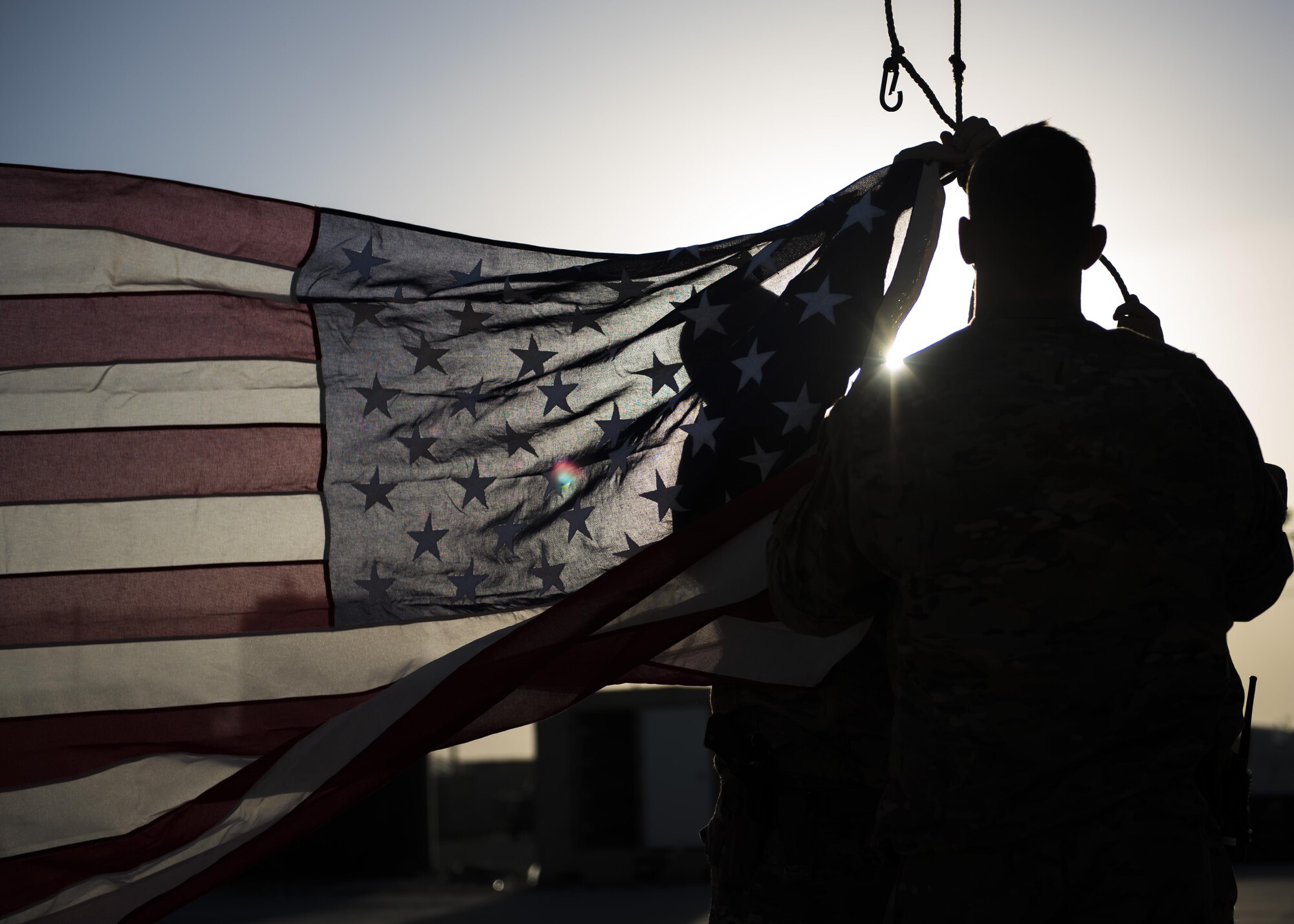 Members of the 455th Expeditionary Civil Engineer Squadron raise a new flag during a flag retirement ceremony at Bagram Airfield, Afghanistan, May 28, 2016. Members of the 455th ECES decided to conduct the ceremony after noticing the flag was worn and soiled. (U.S. Air Force photo by Senior Airman Justyn M. Freeman)
