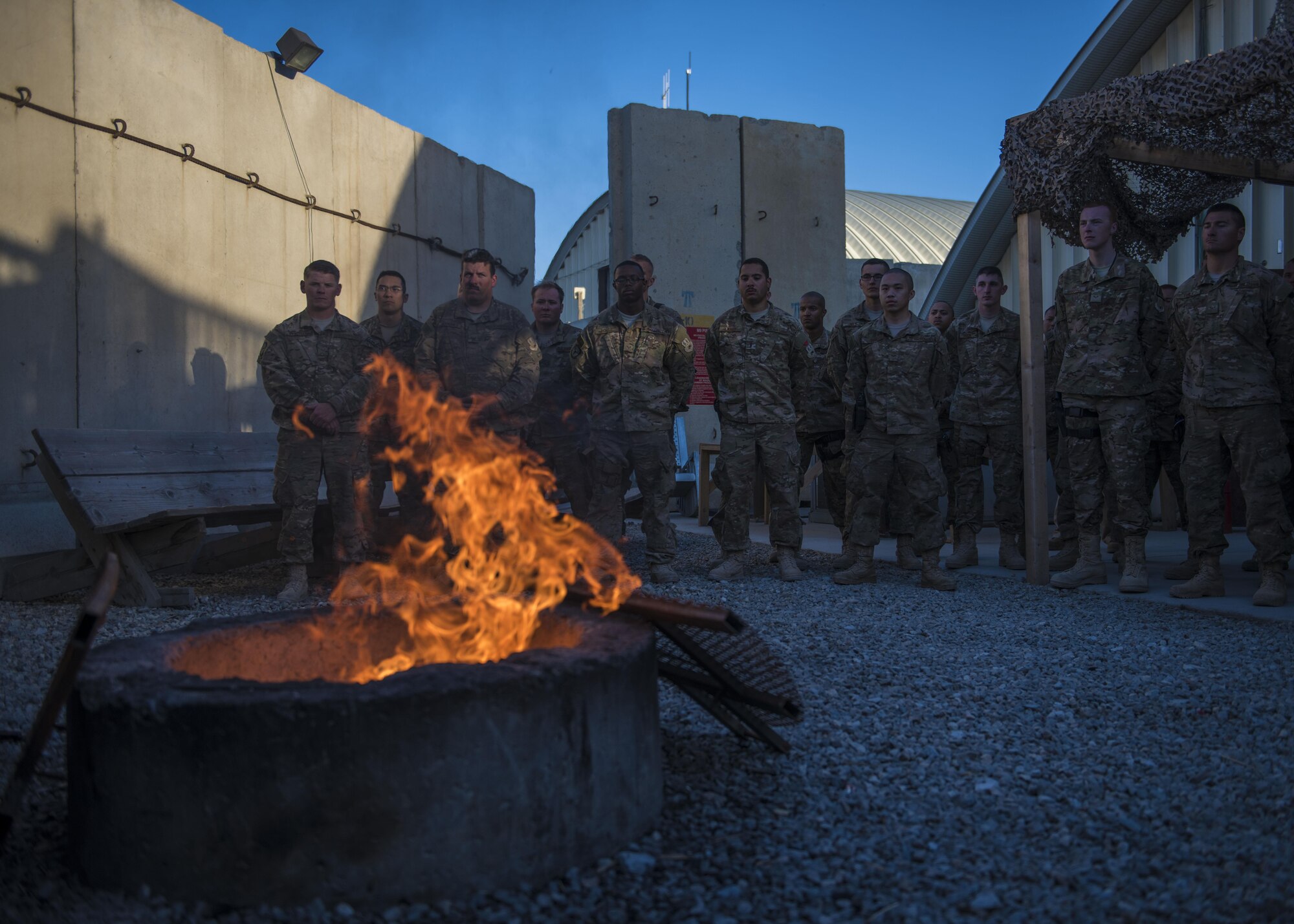Members of the 455th Expeditionary Civil Engineer Squadron show respect during a flag retirement ceremony at Bagram Airfield, Afghanistan, May 28, 2016. When the U.S. flag becomes worn, torn, or soiled, a flag retirement ceremony is conducted to replace the old flag with a new flag. (U.S. Air Force photo by Senior Airman Justyn M. Freeman)