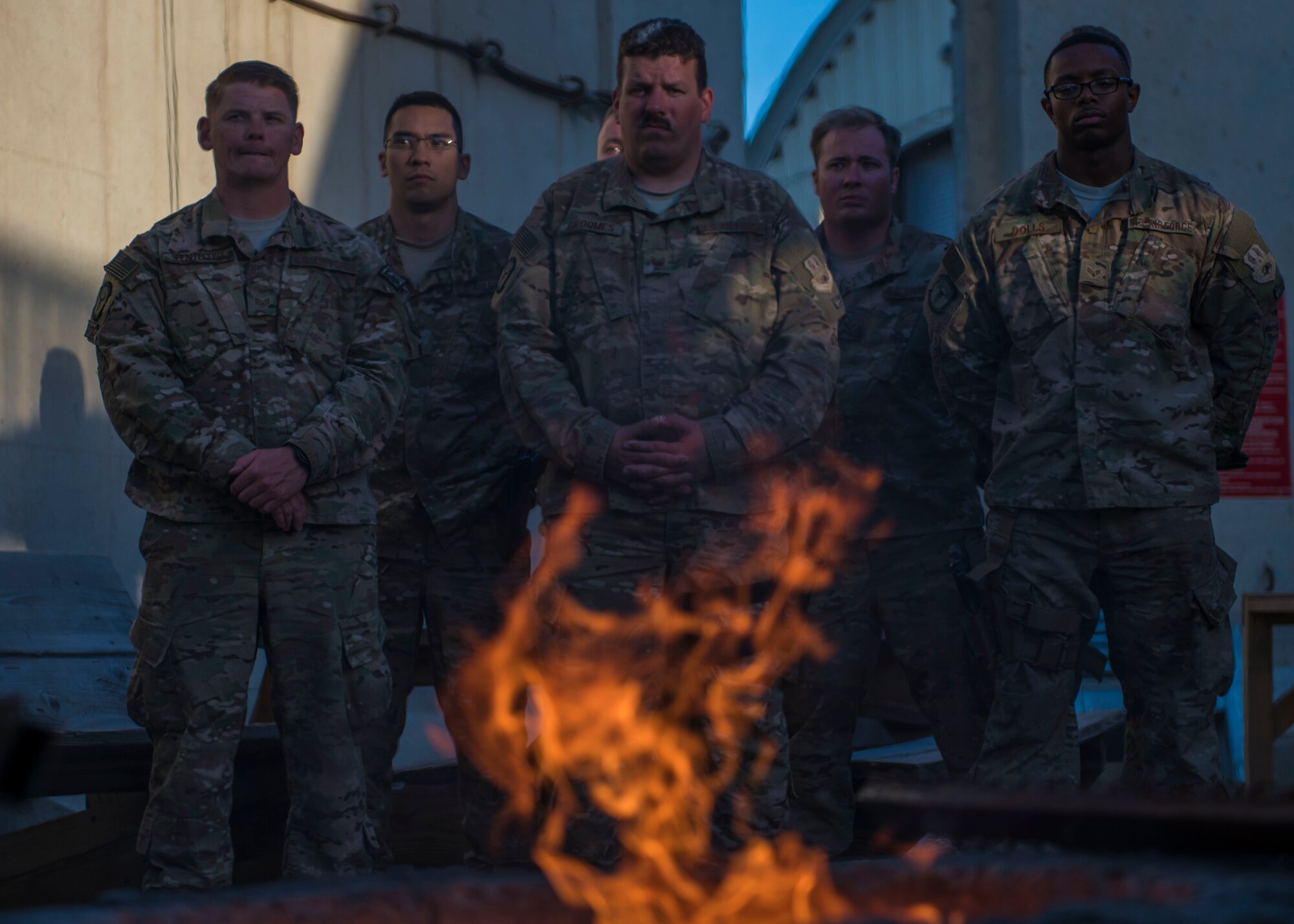 Members of the 455th Expeditionary Civil Engineer Squadron show respect during a flag retirement ceremony at Bagram Airfield, Afghanistan, May 28, 2016. The warn flag that has been flying over the CE compound for years was retired during a retreat ceremony. (U.S. Air Force photo by Senior Airman Justyn M. Freeman)
