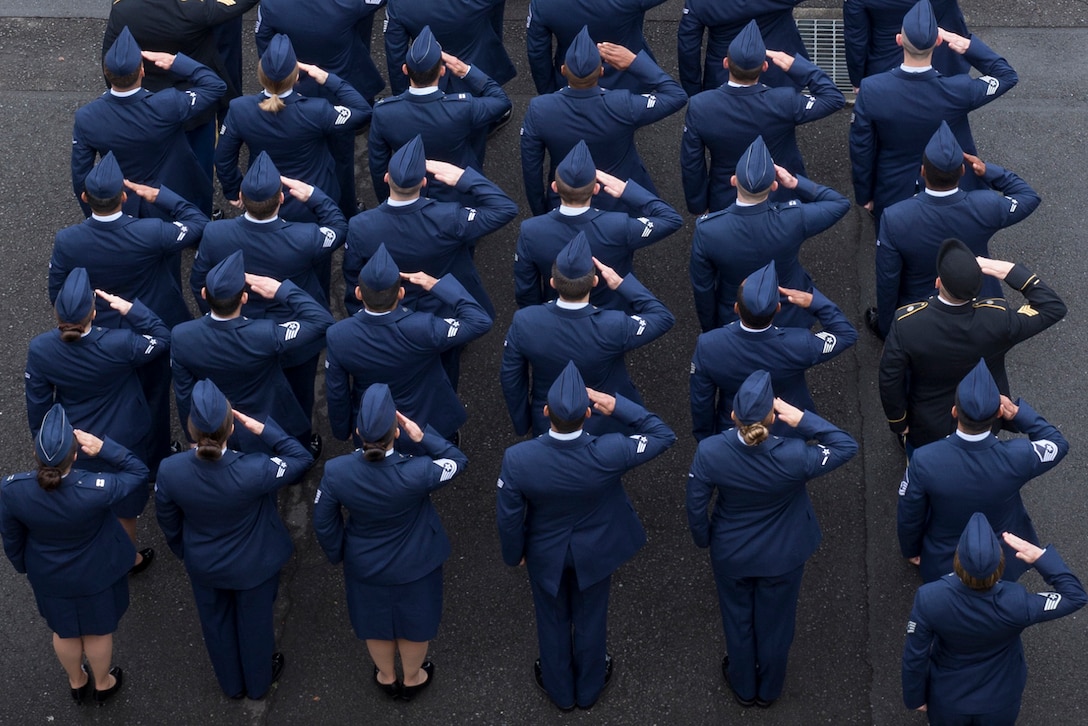 Service members salute during a ceremony for Memorial Day at Yokota Air Base, Japan, May 27, 2016. The 374th Airlift Wing hosted the ceremony. Air Force photo by Yasuo Osakabe