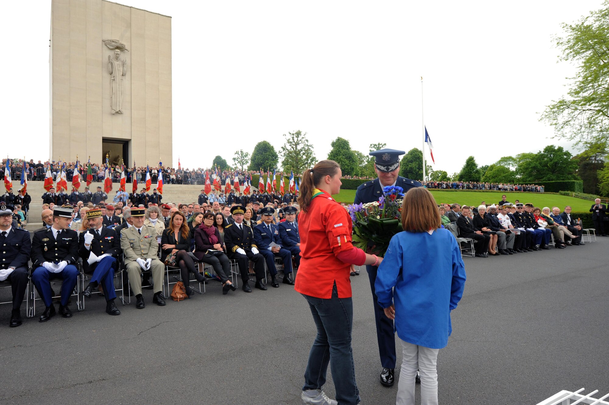 French Girl Scout members present a wreath to Brig. Gen. Jon Thomas, 86th Airlift Wing commander, during a Memorial Day ceremony May 29, 2016, at Lorraine American Cemetery and Memorial, in St. Avold, France. Memorial Day commemorates fallen servicemembers. (U.S. Air Force photo/Staff Sgt. Sharida Jackson)
