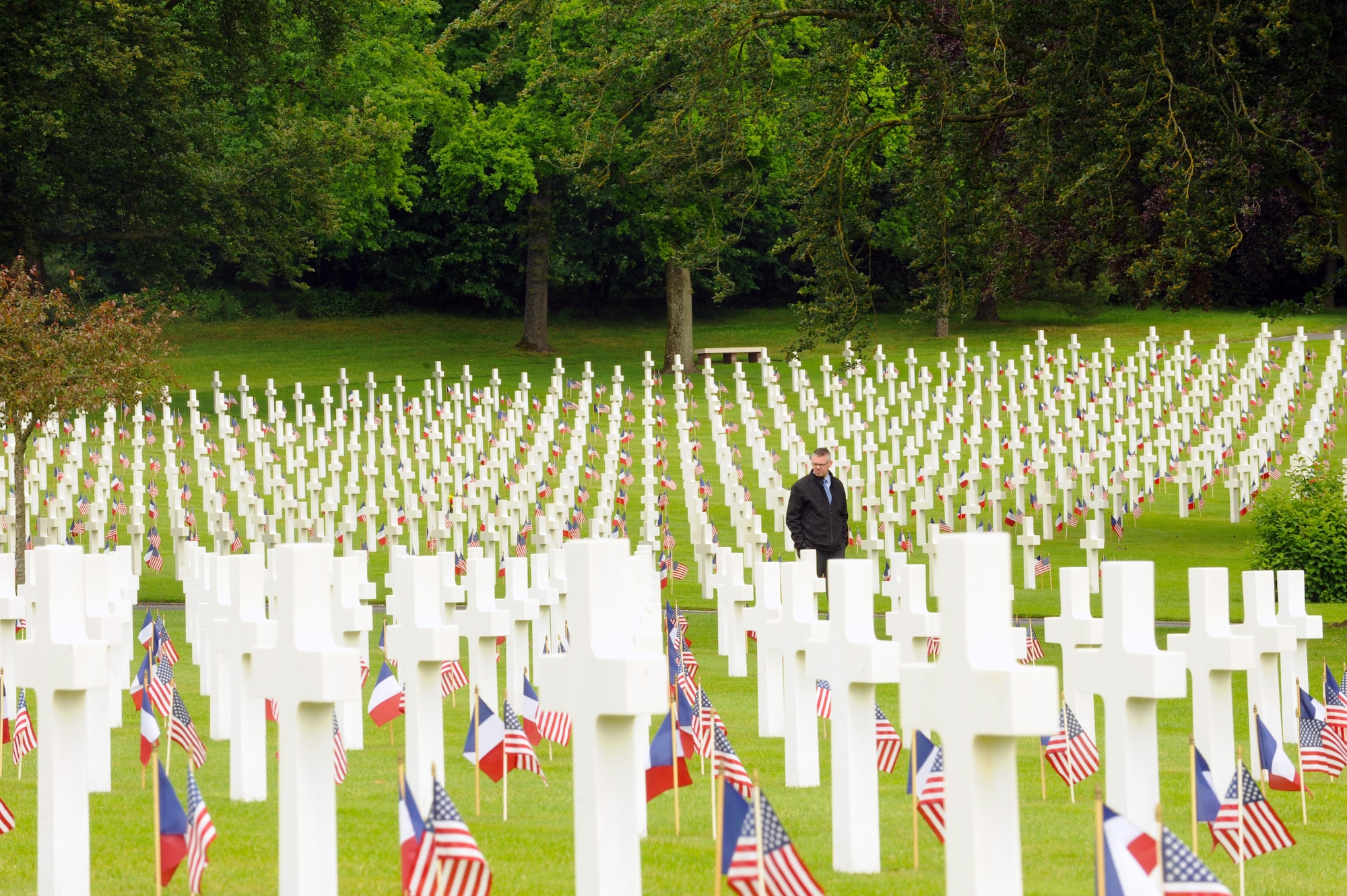 Mr. Philip George, 21st Theater Sustainment Company mortuary affairs, views gravesites during a Memorial Day ceremony May 29, 2016 at Lorraine American Cemetery and Memorial, in St. Avold, France. More than 10,000 Americans are buried in the cemetery, the largest American WWII cemetery in Europe. (U.S. Air Force photo/Staff Sgt. Sharida Jackson)