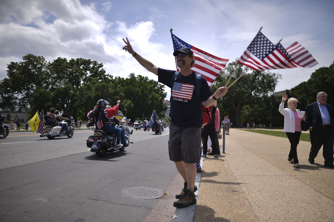 A spectator shows support during the Rolling Thunder demonstration ride in Washington, D.C., May 29, 2016. The annual motorcycle ride and rally, held the day before Memorial Day, draws veterans of all eras and others seeking to pay respects to those who have served. Air National Guard photo by Staff Sgt. Christopher S. Muncy