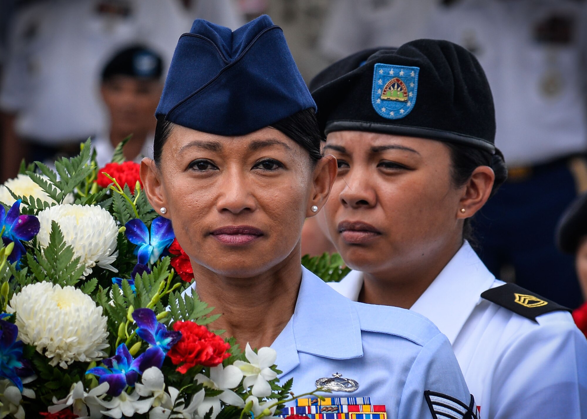 Tech. Sgt. Elsie Cencil, commander support staff NCO with the 254th Red Horse Squadron, carries a wreath May 30, 2016, during a Memorial Day ceremony at the Guam Veterans Cemetery in Piti, Guam. Members from each branch of service and civilian government leaders honored the sacrifices made by all men and women, past and present, in military service to the U.S. (U.S. Air Force photo by Staff Sgt. Alexander W. Riedel/Released)