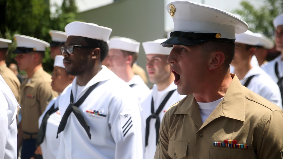 A Marine with 3rd Battalion, 6th Marine Regiment, calls cadence as he marches a platoon of Marines and sailors in the Village of Hastings-on-Hudson, New York during a parade meant to honor fallen veterans, May 29, 2016. This year is the 28th year New York has hosted Fleet Week. U.S. Marines and sailors are in New York to interact with the public, demonstrate capabilities and teach the people of New York about America’s sea service.