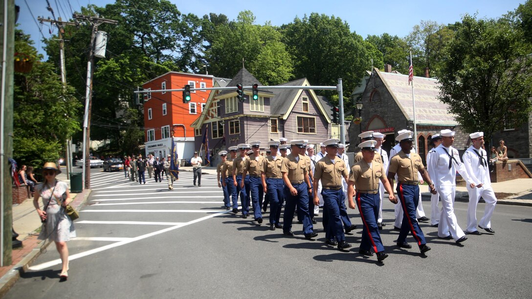 Marines and sailors march down a street in the Village of Hastings-on-Hudson, New York during a parade meant to honor fallen veterans, May 29, 2016. This year is the 28th year New York has hosted Fleet Week. U.S. Marines and sailors are in New York to interact with the public, demonstrate capabilities and teach the people of New York about America’s sea service.