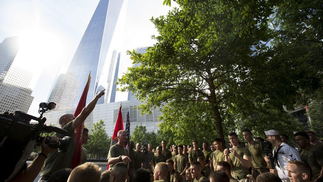 Sgt. Maj. Douglas F. Cutsail, left, 24th Marine Expeditionary Unit sergeant major, discusses the significance of the 9/11 Memorial to Marines and sailors following the the Freedom Run  as part of Fleet Week in New York, May 29, 2016. Service members from U.S. Marine Corps, U.S. Navy and Candadian Navy ran from the North Cove Marina to the 9/11 Memorial to honor the fallen.
