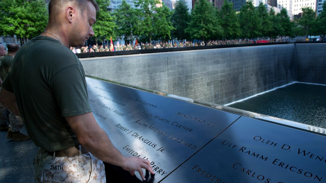 Maj. Nicholas Smith, a logistics officer with the 24th Marine Expeditionary Unit, reads a name on the 9/11 Memorial after the Freedom Run as part of Fleet Week in New York, May 29, 2016. Service members from the U.S. Marine Corps, U.S. Navy and Canadian Navy ran from the North Cove Marina to the 9/11 Memorial to honor the fallen.
