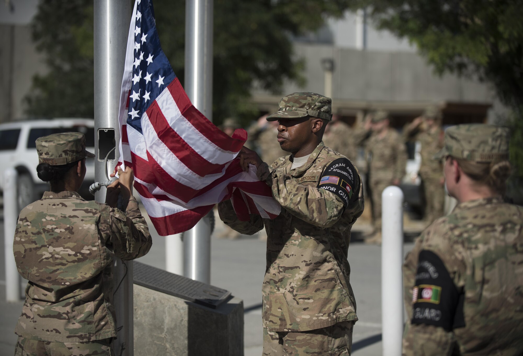 Members of the base Honor Guard team prepare to fold the flag during the Memorial Day remembrance ceremony at Bagram Airfield, Afghanistan, May 30, 2016. Memorial Day, which was first known as Decoration Day, was created during the Civil War. It was proclaimed in 1868 by General John Logan, national commander of the Grand Army of the Republic. The day became a national holiday with the Congressional passage of the National Holiday Act in 1971. (U.S. Air Force photo by Tech. Sgt. Tyrona Lawson)