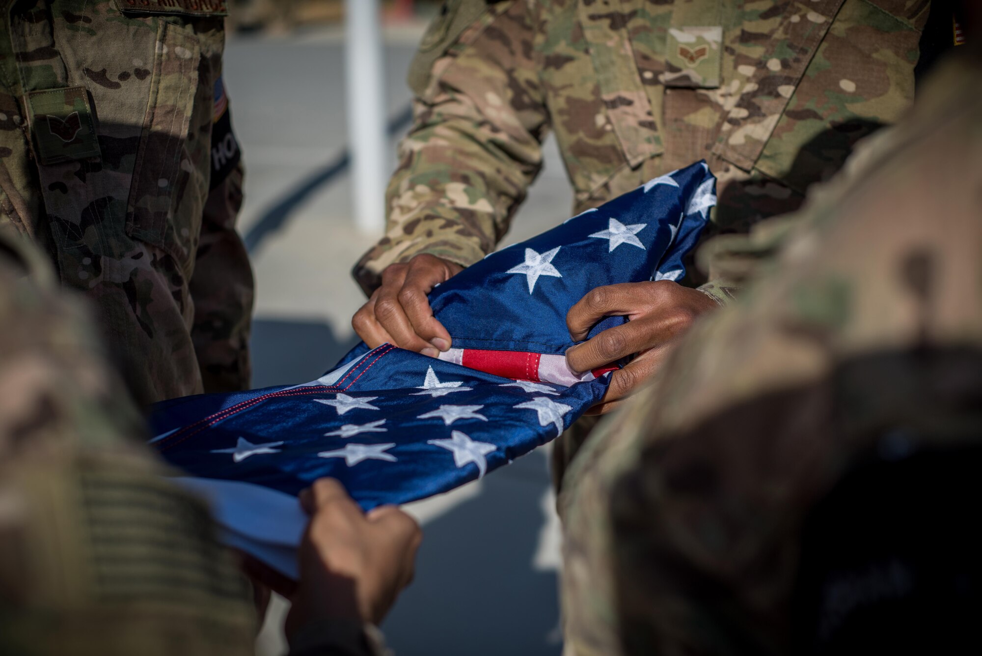 Members of the base Honor Guard team prepare to fold the flag during the Memorial Day Remembrance ceremony at Bagram Airfield, Afghanistan, May 30, 2016. Memorial Day, which was first known as Decoration Day, was created during the Civil War. It was proclaimed in 1868 by General John Logan, national commander of the Grand Army of the Republic. The day became a national holiday with the Congressional passage of the National Holiday Act in 1971. (U.S. Air Force photo by Senior Airman Robert Dantzler)