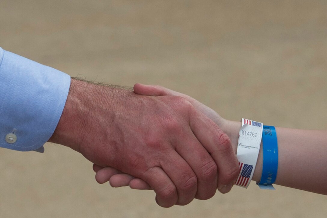 Defense Secretary Ash Carter shakes hands with one of more than 350 children and counselors from the Tragedy Assistance Program for Survivors, or TAPS, at the Pentagon, May 27, 2016, as part of program's annual Military Survivor Seminar and Good Grief camp for young survivors. DoD photo by Air Force Senior Master Sgt. Adrian Cadiz