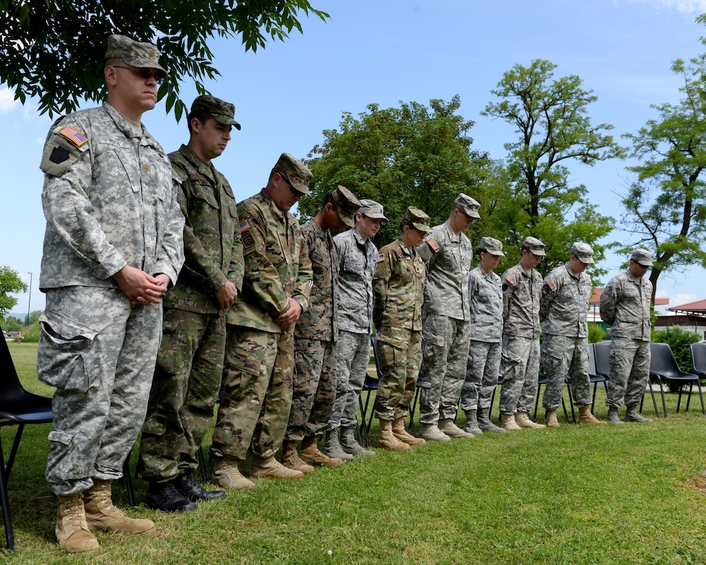U.S. service members take a moment of silence to honor the fallen during a Memorial Day ceremony at Camp Butmir in Sarajevo, Bosnia-Herzegovina, May 30, 2016.