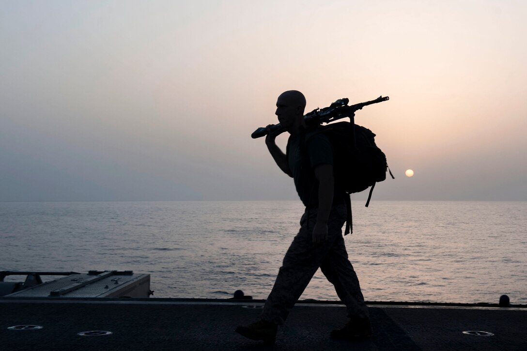 A Marine participates in a sunrise ruck march honoring fallen service members as he marks Memorial Day on the flight deck of the USS Boxer in the Gulf of Aden, May 28, 2016. Navy photo by Seaman Eric Burgett