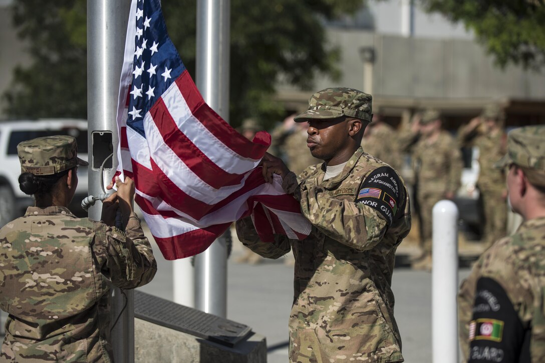 Members of the honor guard prepare to fold the flag during the Memorial Day remembrance ceremony at Bagram Airfield, Afghanistan, May 30, 2016. Air Force photo by Tech. Sgt. Tyrona Lawson