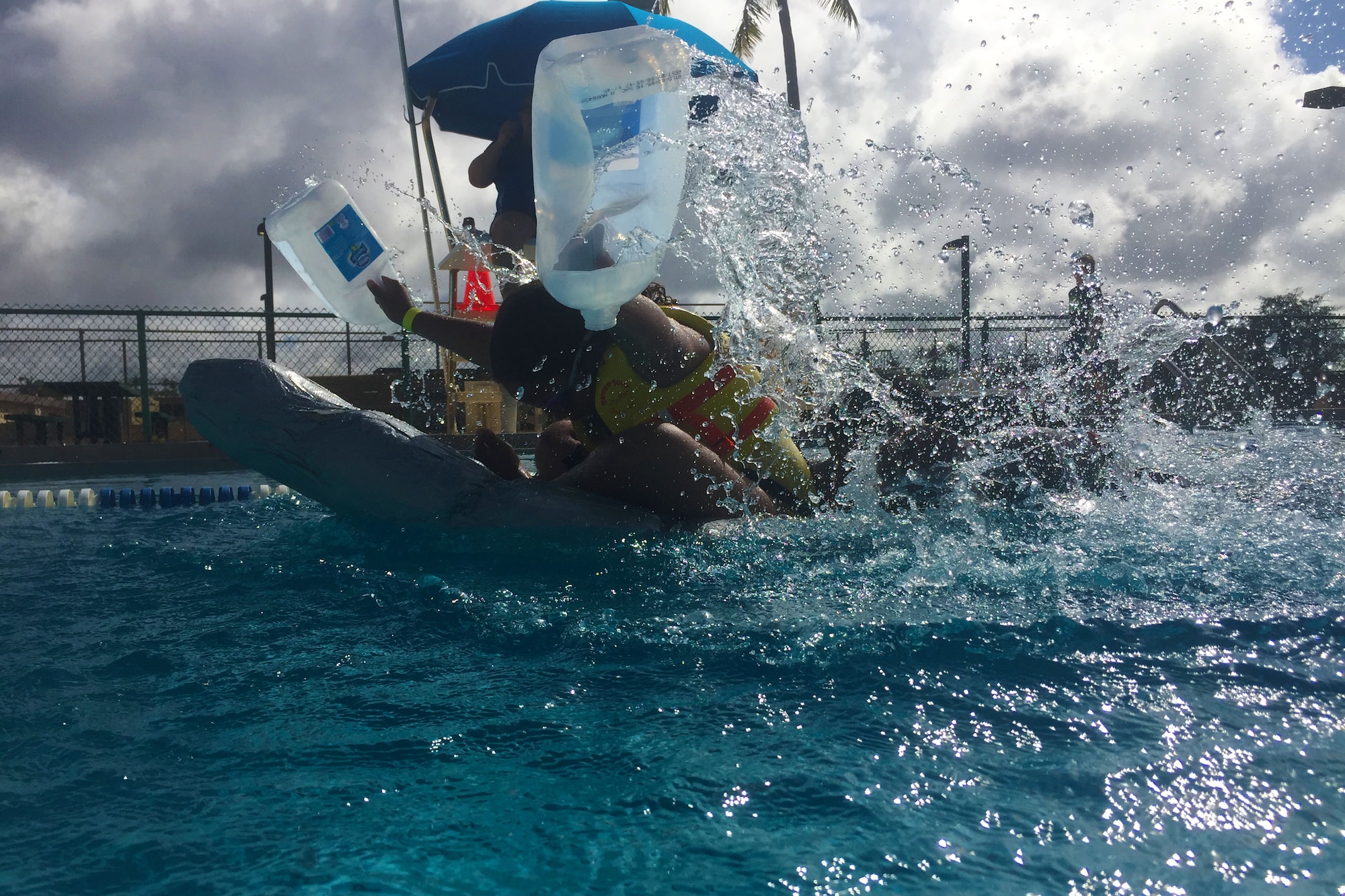 Tech. Sgt. Robert Terrell, 36th Munitions Squadron, and his daughter, Brooklyn, race a homemade boat across the finish line during the Boat Blitz May 25, 2016, at Andersen Air Force Base, Guam. To create their first place winning boat and oars, the father-daughter duo used more than six rolls of duct tape in addition to dozens of plastic bottles. (U.S. Air Force photo by Airman 1st Class Alexa Ann Henderson)