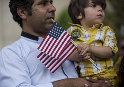 A man holds his son on Constitution Avenue to watch the 2016 National Memorial Day Parade in Washington, D.C., May 30. Approximately a hundred U.S. Army Reserve Soldiers marched in this year's parade, represented by the 200th Military Police Command, from Fort Meade, Maryland; the 55th Sustainment Brigade, from Fort Belvoir, Virginia; and the Military Intelligence Readiness Command, from Fort Belvoir. (U.S. Army photo by Master Sgt. Michel Sauret)