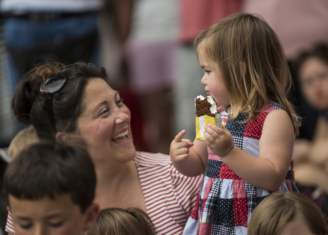 A woman laughs with her daughter along Constitution Avenue while watching the 2016 National Memorial Day Parade in Washington, D.C., May 30. Approximately a hundred U.S. Army Reserve Soldiers marched in this year's parade, represented by the 200th Military Police Command, from Fort Meade, Maryland; the 55th Sustainment Brigade, from Fort Belvoir, Virginia; and the Military Intelligence Readiness Command, from Fort Belvoir. (U.S. Army photo by Master Sgt. Michel Sauret)