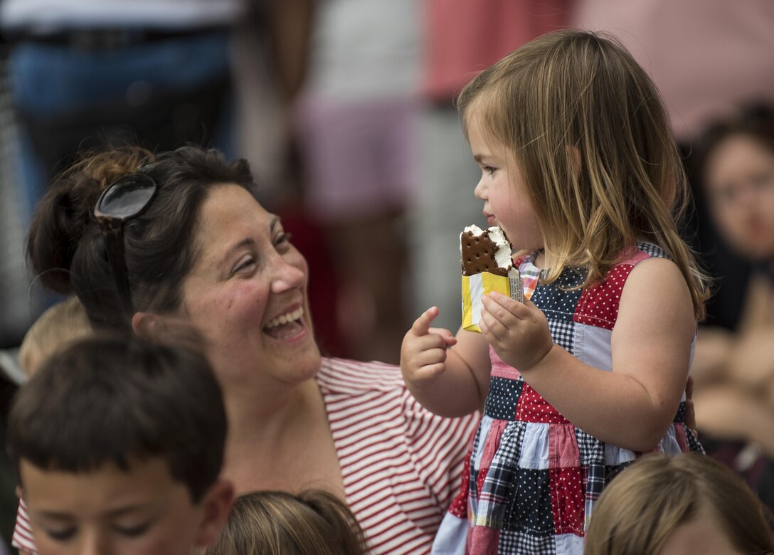 A woman laughs with her daughter along Constitution Avenue while watching the 2016 National Memorial Day Parade in Washington, D.C., May 30. Approximately a hundred U.S. Army Reserve Soldiers marched in this year's parade, represented by the 200th Military Police Command, from Fort Meade, Maryland; the 55th Sustainment Brigade, from Fort Belvoir, Virginia; and the Military Intelligence Readiness Command, from Fort Belvoir. (U.S. Army photo by Master Sgt. Michel Sauret)