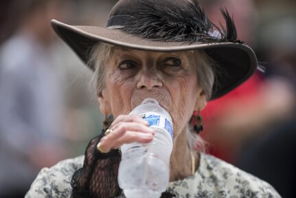 Liz Groszner, member of the historical organization called Order of the Confederate Rose, takes a drink of water to cool off from the afternoon heat before the start of the 2016 National Memorial Day Parade in Washington, D.C., May 30. (U.S. Army photo by Master Sgt. Michel Sauret)