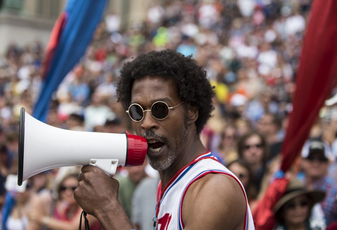A man shouts into a megaphone to pump up the crowd along Constitution Avenue during the 2016 National Memorial Day Parade in Washington, D.C., May 30. Approximately a hundred U.S. Army Reserve Soldiers marched in this year's parade, represented by the 200th Military Police Command, from Fort Meade, Maryland; the 55th Sustainment Brigade, from Fort Belvoir, Virginia; and the Military Intelligence Readiness Command, from Fort Belvoir. (U.S. Army photo by Master Sgt. Michel Sauret)