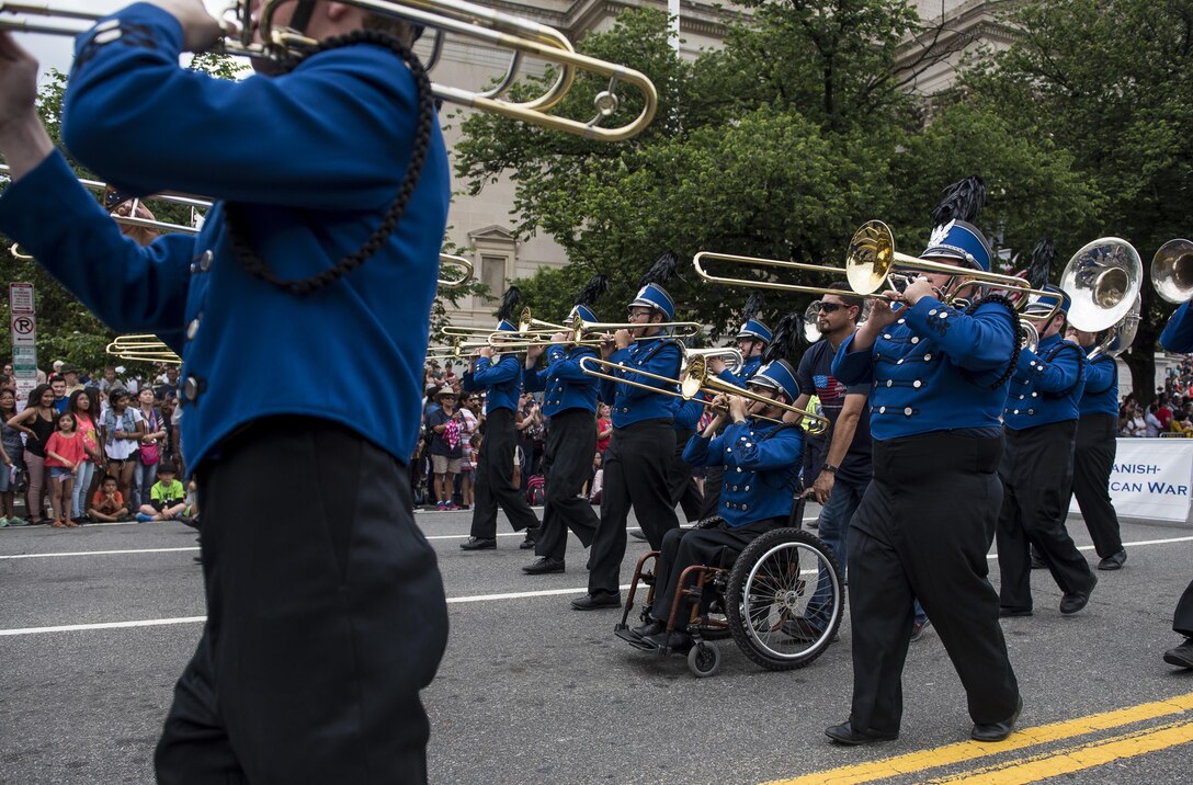 A high school marching band performs along Constitution Avenue in the 2016 National Memorial Day Parade in Washington, D.C., May 30. Approximately a hundred U.S. Army Reserve Soldiers marched in this year's parade, represented by the 200th Military Police Command, from Fort Meade, Maryland; the 55th Sustainment Brigade, from Fort Belvoir, Virginia; and the Military Intelligence Readiness Command, from Fort Belvoir. (U.S. Army photo by Master Sgt. Michel Sauret)