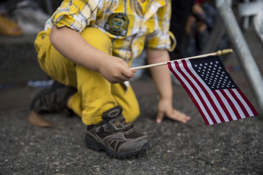 A boy sneaks under a street barrier to get a better view of the 2016 National Memorial Day Parade in Washington, D.C., May 30. Approximately a hundred U.S. Army Reserve Soldiers marched in this year's parade, represented by the 200th Military Police Command, from Fort Meade, Maryland; the 55th Sustainment Brigade, from Fort Belvoir, Virginia; and the Military Intelligence Readiness Command, from Fort Belvoir. (U.S. Army photo by Master Sgt. Michel Sauret)