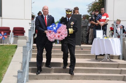 U.S. Navy Adm. Cecil D. Haney, U.S. Strategic Command (USSTRATCOM) commander (right), and Nebraska Governor Pete Ricketts carry a ceremonial wreath to the memorial site during the Heroes of the Heartland Foundation Memorial Day event at Memorial Park, Omaha, Neb., May 30, 2016. The wreath was one of several that were placed at the memorial in honor of all veterans - living and deceased - who served in the armed forces and fire or police departments. During the event, Haney and Ricketts joined other state and national government leaders, veterans and members of the Omaha-area community in recognizing the courage, legacy and service of those who gave their lives to guarantee the freedoms and liberties Americans enjoy today. Haney also provided remarks, during which he thanked current and former service members and their families for keeping the nation safe and reminded attendees to remember, respect and honor those who made the ultimate sacrifice. The tradition of honoring fallen war veterans dates back to May 5, 1868 - three years after the Civil War ended - when the head of the Grand Army of the Republic, an organization of Union veterans, established "Decoration Day" as a time for the nation to decorate the graves of the war dead with flowers. The first large observance was held at Arlington National Cemetery, Virginia. In 1971, Memorial Day was declared a national holiday by an act of Congress and was placed on the last Monday of May. (USSTRATCOM photo by Steve Cunningham)\r\nMore photos at: https://www.flickr.com/photos/usstratcom/albums/72157668754772521