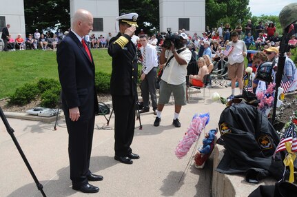 U.S. Navy Adm. Cecil D. Haney, U.S. Strategic Command (USSTRATCOM) commander (second from left), and Nebraska Governor Pete Ricketts pay their respects after laying a wreath at the memorial site during the Heroes of the Heartland Foundation Memorial Day event at Memorial Park, Omaha, Neb., May 30, 2016. Several wreaths were placed at the memorial in honor of all veterans - living and deceased - who served in the armed forces and fire or police departments. During the event, Haney and Ricketts joined other state and national government leaders, veterans and members of the Omaha-area community in recognizing the courage, legacy and service of those who gave their lives to guarantee the freedoms and liberties Americans enjoy today. Haney also provided remarks, during which he thanked current and former service members and their families for keeping the nation safe and reminded attendees to remember, respect and honor those who made the ultimate sacrifice. The tradition of honoring fallen war veterans dates back to May 5, 1868 - three years after the Civil War ended - when the head of the Grand Army of the Republic, an organization of Union veterans, established "Decoration Day" as a time for the nation to decorate the graves of the war dead with flowers. The first large observance was held at Arlington National Cemetery, Virginia. In 1971, Memorial Day was declared a national holiday by an act of Congress and was placed on the last Monday of May. (USSTRATCOM photo by Steve Cunningham)\r\nMore photos at: https://www.flickr.com/photos/usstratcom/albums/72157668754772521