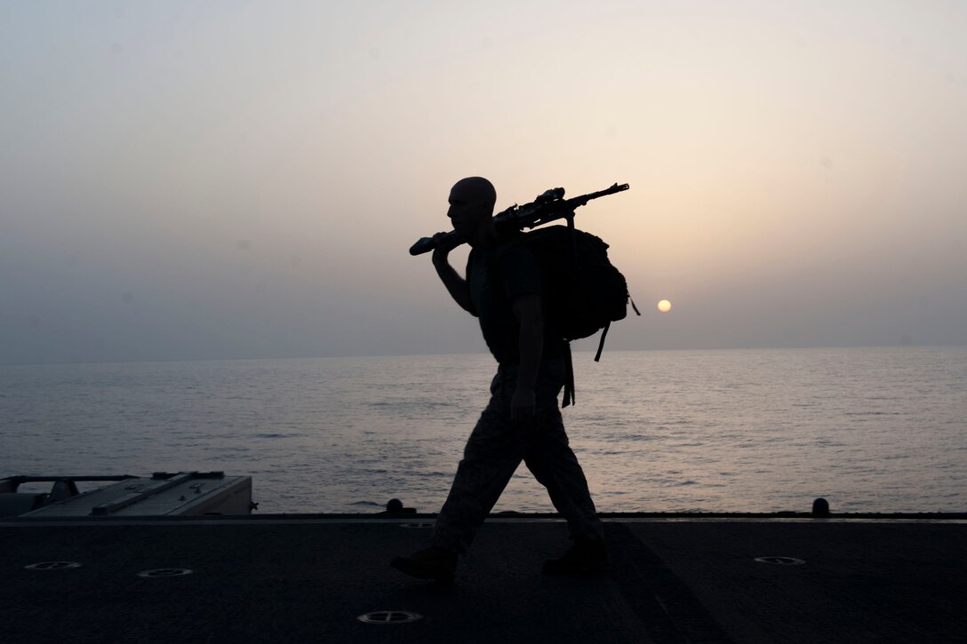 A Marine participates in a sunrise ruck march honoring fallen service members as he marks Memorial Day on the flight deck of the USS Boxer in the Gulf of Aden, May 28, 2016. Navy photo by Seaman Eric Burgett