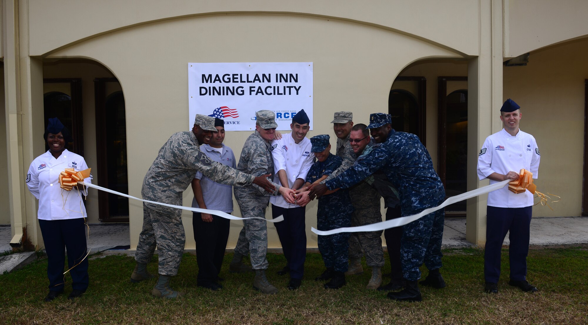 Joint Region Marianas leaders cut a ribbon to symbolize the opening of the Magellan Inn Dining Facility May 26, 2016, at Andersen Air Force Base, Guam. The remodeled dining facility offers improved serving lines, charging stations where customers can charge their electronic devices and more menu options for Airmen. (U.S. Air Force photo by Senior Airman Joshua Smoot)