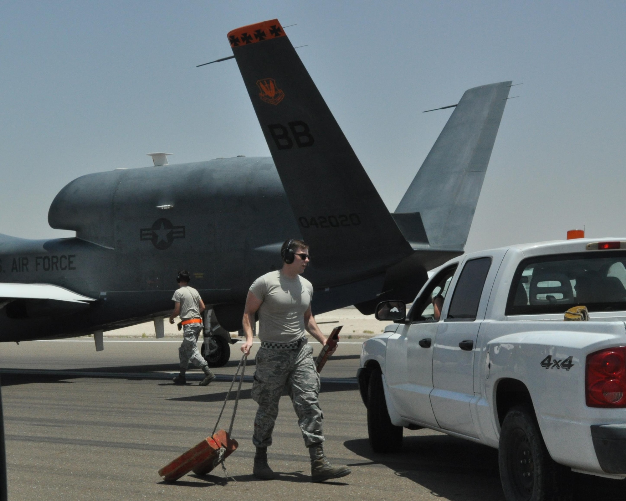 Airman 1st Class Dylan (front) and Senior Airman Bradley (back), 380th Expeditionary Aircraft Maintenance Squadron Global Hawk technicians, work to prep an RQ-4 Global Hawk for towing, May 16, after its flight. With the support of these Airmen, the Global Hawk is able to deliver all-weather, day or night intelligence, surveillance and reconnaissance to support U.S. Air Force Central Command missions. (U.S. Air Force photo by Staff Sgt. Samantha Mathison)