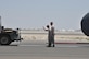 Staff Sgt. Phillip (left) and Senior Airman Alan (right), 380th Expeditionary Aircraft Maintenance Squadron Global Hawk technicians, spot a reversing vehicle to connect a tow bar to a RQ-4 Global Hawk, May 16. The Global Hawk is capable of providing near real-time information to assist in saving lives during worldwide peacetime, contingency and wartime operations. (U.S. Air Force photo by Staff Sgt. Samantha Mathison)