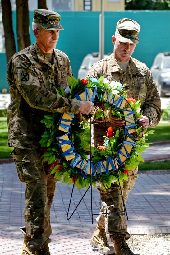 Army Gen. John W. Nicholson, Jr., left, commander of U.S. and NATO forces in Afghanistan, and Army Command Sergeant Major Byers place a wreath at a monument during the Memorial Day remembrance ceremony in Kabul, Afghanistan, May 28, 2016. Army photo