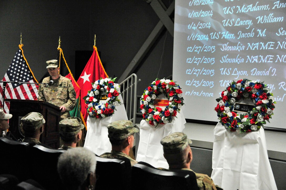 Army Chaplain (Maj.) Jeffrey Bailey, standing left, U.S. Forces Afghanistan command chaplain, gives the invocation and introduction to the command leadership during the Memorial Day remembrance ceremony at Bagram Airfield, Afghanistan, May 28, 2016. Army photo by Bob Harrison