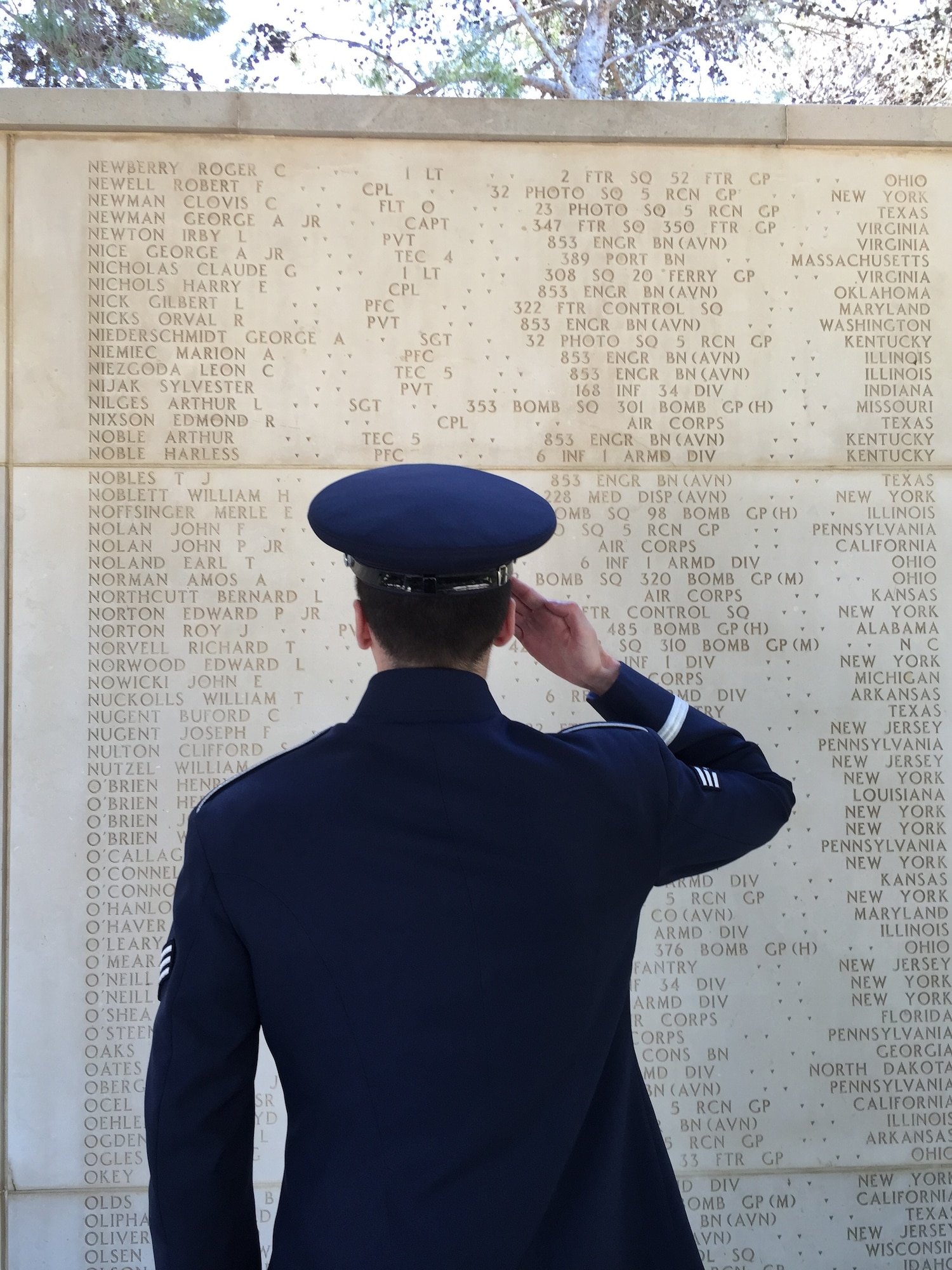 Senior Airman Colby Fahrenbacher, U.S. Air Forces in Europe Band member, salutes the name of his great-uncle at the North African American Cemetery in Tunisia, May 30, 2016. Fahrenbacher's great-uncle, Tech. Sgt. Merle Noffsinger was a B-24 gunner and bombardier who was shot down May 1, 1943. (U.S. Air Force photo by Staff Sgt. Will McCrary/Released). 