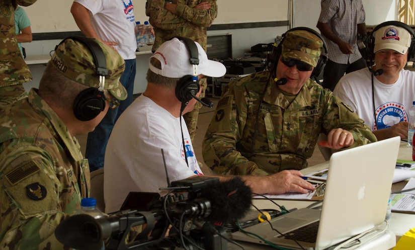 Maj. Gen. Richard C. Nash, the adjutant general of the Minnesota Nation Guard, and Pat Harris (far-right), one of the founders and organizers of the Feed Our Troops project, participate in a live-radio interview with Minnesota Military Radio during a Feed Our Troops event at Camp Arifjan, Kuwait, May 15, 2016. Nearly 3,700 steak dinners were brought from Saint Paul, Minnesota, for Soldiers of the 682nd Engineer Bn., Minnesota National Guard and U.S. Army Central.