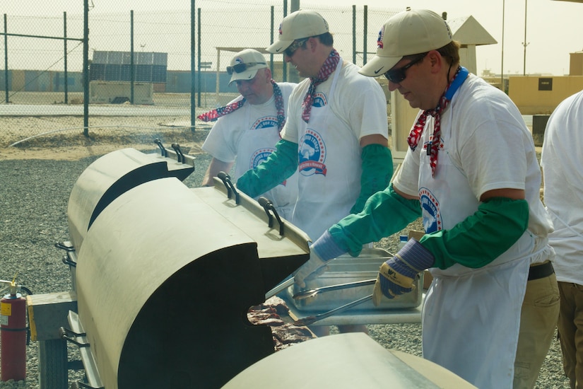 Ted Johnson (front) and Paul Dzubnar (middle), volunteer grill masters, prepare steaks for Servicemembers during a Feed Our Troops event at Camp Arifjan, Kuwait, May 15, 2016. Nearly 3,700 steak dinners were brought from Saint Paul, Minnesota, for Soldiers of the 682nd Engineer Bn., Minnesota National Guard and U.S. Army Central.