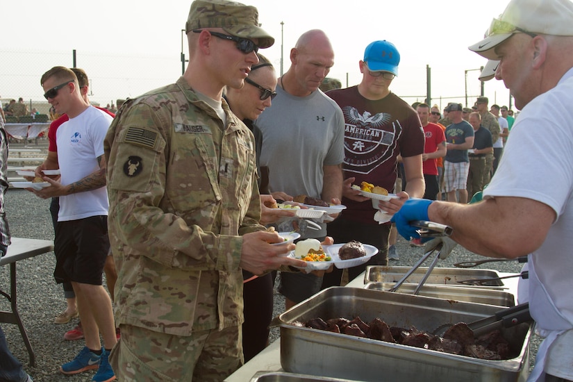 1st Lt. Lance Hauser, with Headquarters and Headquarters Company, 682nd Engineer Bn., Minnesota National Guard and U.S. Army Central Servicemembers line up to receive steaks brought in from Saint Paul, Minnesota, during a Feed Our Troops event at Camp Arifjan, Kuwait, May 15, 2016. Nearly 3,700 steak dinners were brought from Saint Paul, Minnesota, for Soldiers of the 682nd Engineer Bn., Minnesota National Guard and U.S. Army Central.