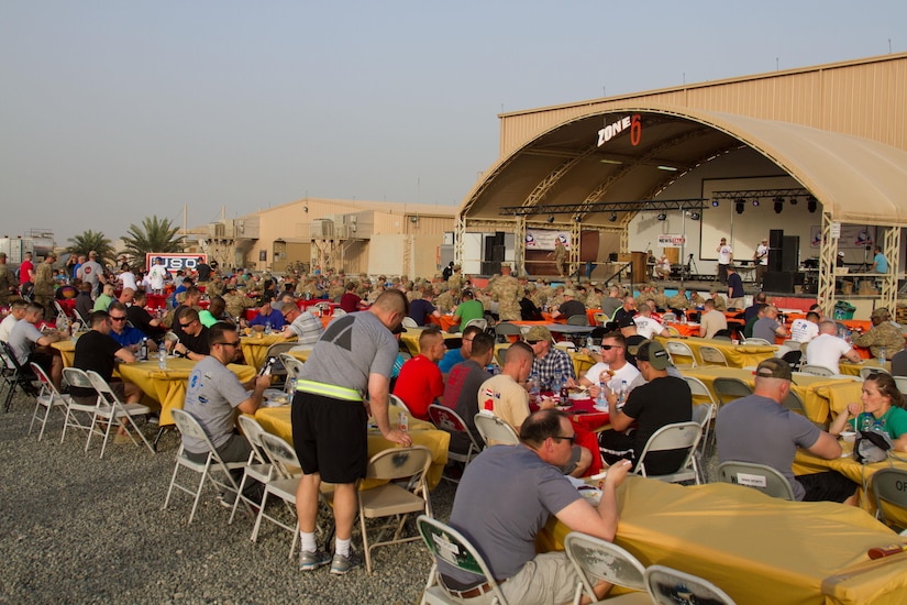 Servicemembers eat steak dinners while listening to a live performance from the Chris Hawkeye Band during a Feed Our Troops event at Camp Arifjan, Kuwait, May 15, 2016. Nearly 3,700 steak dinners were brought from Saint Paul, Minnesota, for Soldiers of the 682nd Engineer Bn., Minnesota National Guard and U.S. Army Central.