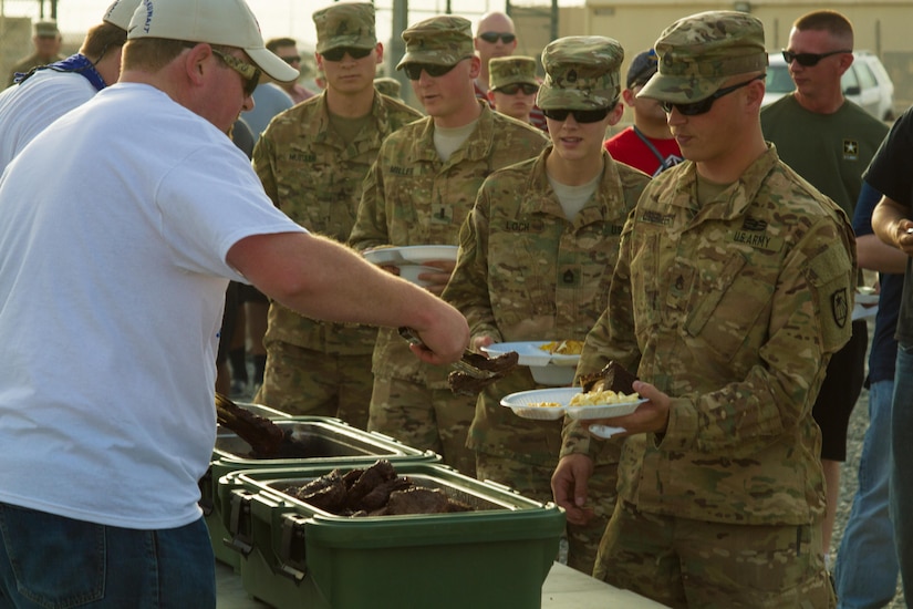 Soldiers of the 682nd Engineer Battalion, Minnesota National Guard and U.S. Army Central file through a serving line to receive steaks brought from Saint Paul, Minnesota, during a Feed Our Troops event at Camp Arifjan, Kuwait, May 15, 2016. Nearly 3,700 steak dinners were brought from Saint Paul, Minnesota, for Soldiers of the 682nd Engineer Bn., Minnesota National Guard and U.S. Army Central.